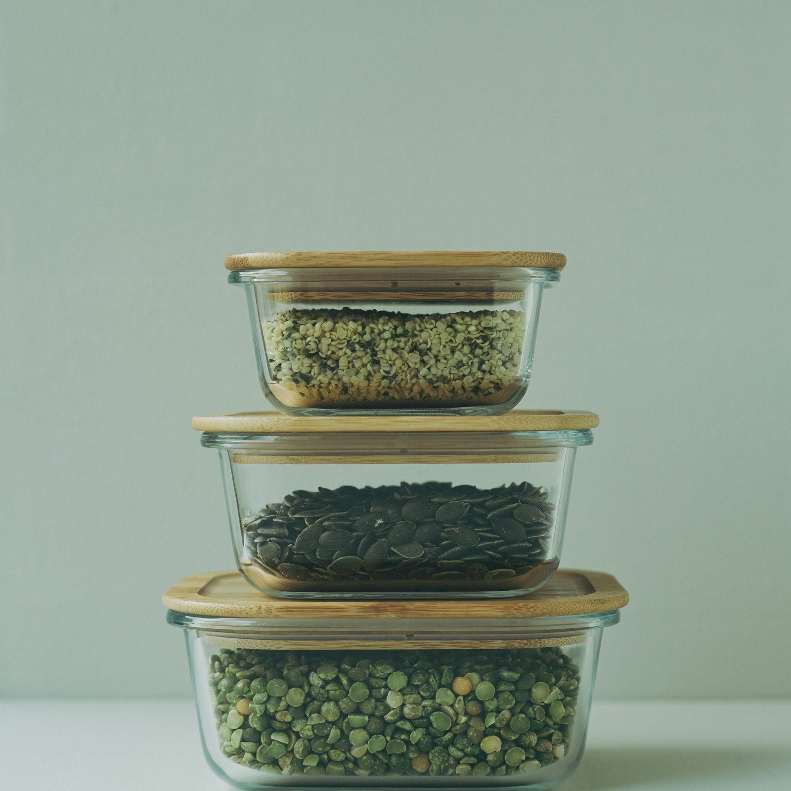 three glass containers filled with different types of food